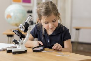 Elementary schoolgirl in science class