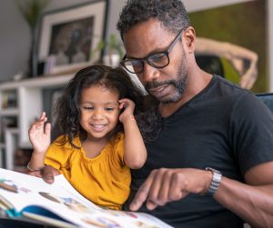 father reading with daughter