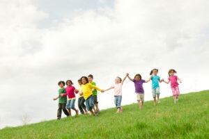 Diverse children outside on the grass - Buy credits