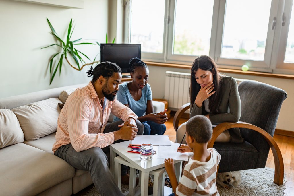 home visitor and family watching child